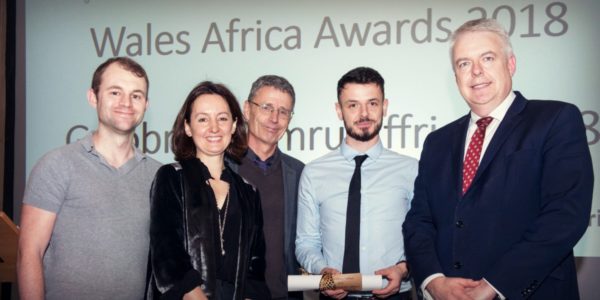 L-R: * Climate Scientist Tim Wilkes, Cat Jones, Head of Partnership, Hub Cymru Africa, Ru Hartwell, Community Carbon Link Director & Trustee The Word Forest Organisation, * Climate Scientist Zak Douglas, receiving the award from the Right Honourable Carwyn Jones AM, First Minister. (* Both from the Department of Geography & Earth Sciences at Aberystwyth University).