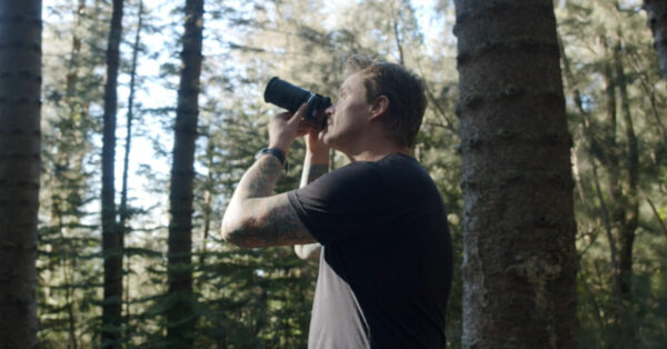 A man photographing a tree