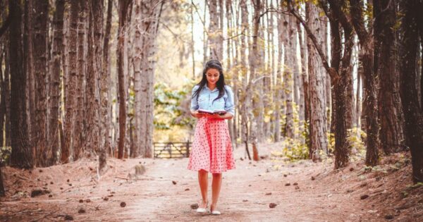a woman reading in the forest