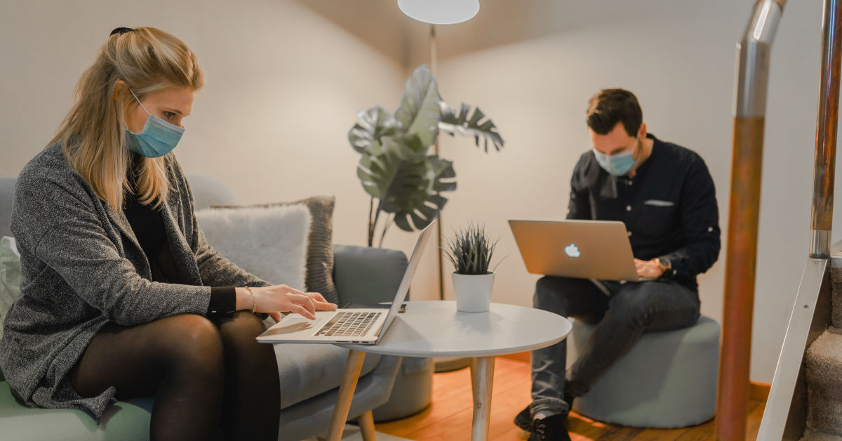 Two students together wearing masks in online meetings by Maxime on Unsplash