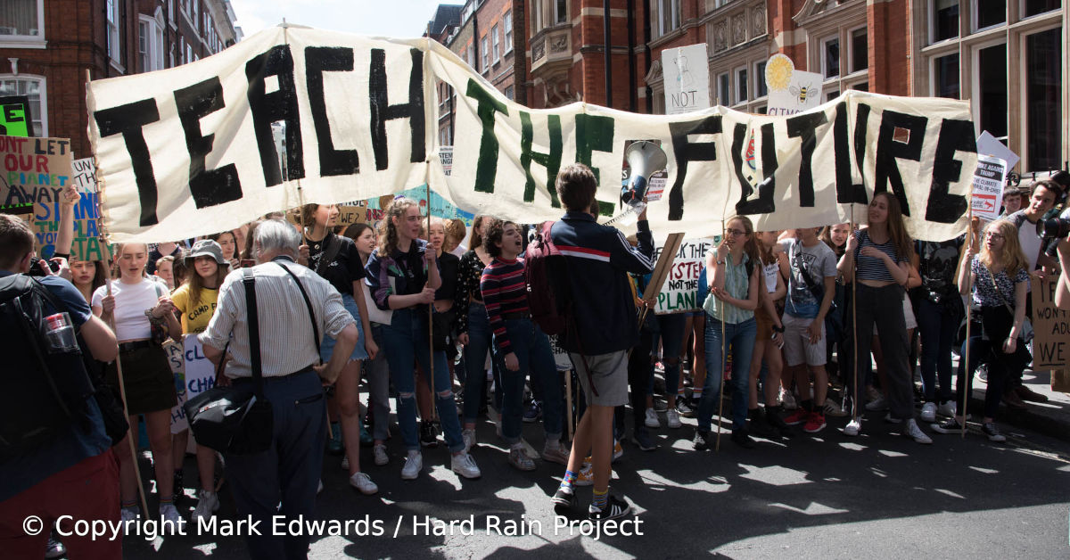 Protesting students holding a Teach The Future banner. Image by Mark Edwards